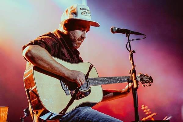 Chuck Ward playing his guitar on stage